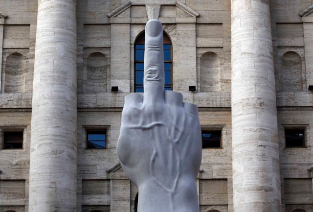A sculpture called " crippled hand" from Italian sculptor Maurizio Cattelan is placed in front of stock exchange palace in Milan